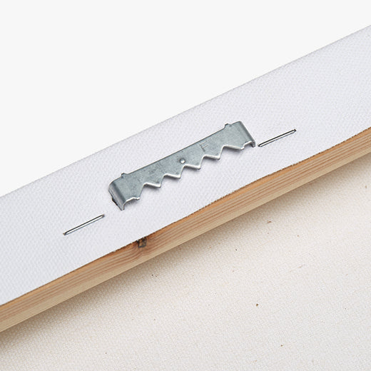 Back of the personalized matte canvas: metal tack and wooden picture frame on a white background