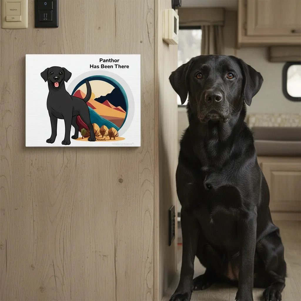 Personalized matte canvas art with a dog illustration, dog name, "Has Been There" badge, and desert illustration, and a black Labrador dog is sitting in front of it. Outdoor Adventure Series.