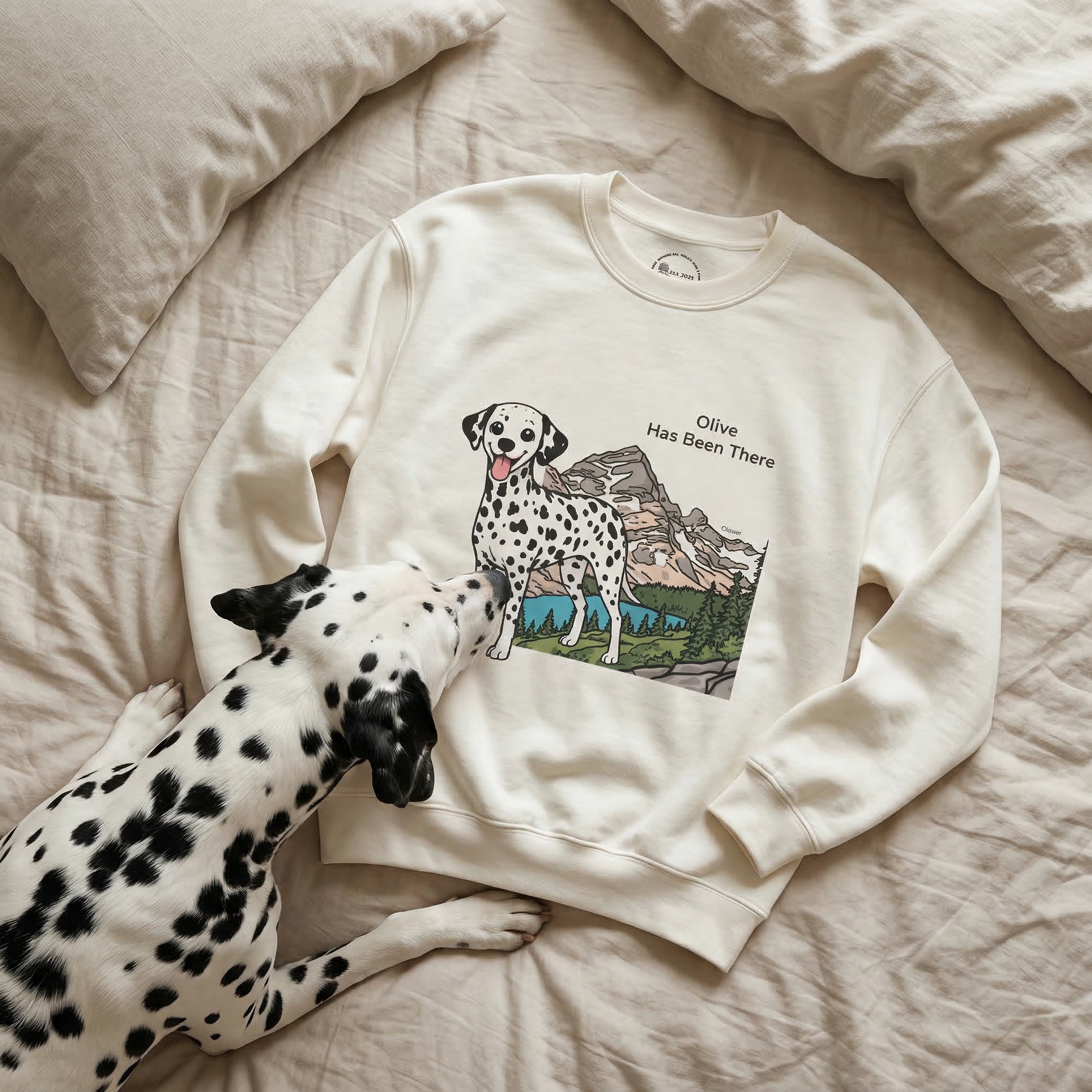 White sweatshirt with Dalmatian custom design on a bed with a Dalmatian dog.