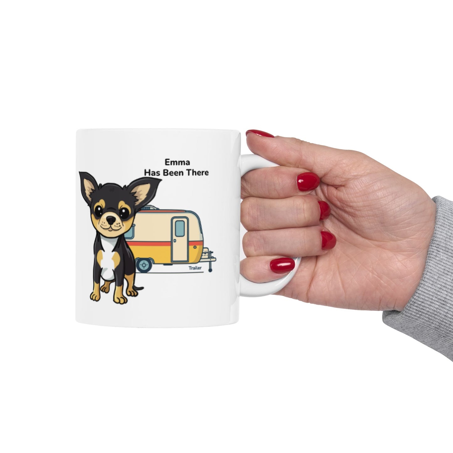 Hand holding a personalized mug, photographed from the right hand side with a dog illustration, dog name, "Has Been There" badge, and trailer illustration. Outdoor Adventure Series.