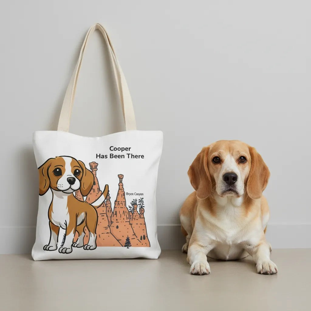 Personalized Tote bag with a dog illustration, dog name, "Has Been There" badge, and Bryce Canyon illustration, lying on the ground with a Beagle next to it. National Park Series.